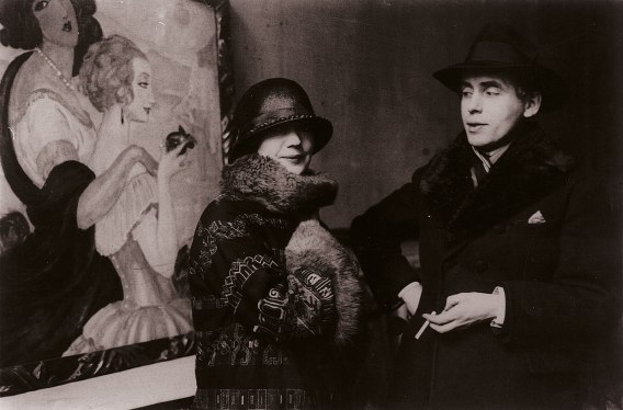 gerda-and-einar-wegener-in-front-of-gerdas-painting-sur-la-route-danacapri-during-the-exhibition-in-ole-haslunds-hus1924-photo-the-royal-library-denmark